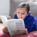 mockup-of-a-happy-girl-reading-a-book-while-on-the-floor-a19100