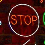 Neon signs on a brick wall in a restaurant