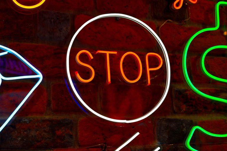 Neon signs on a brick wall in a restaurant