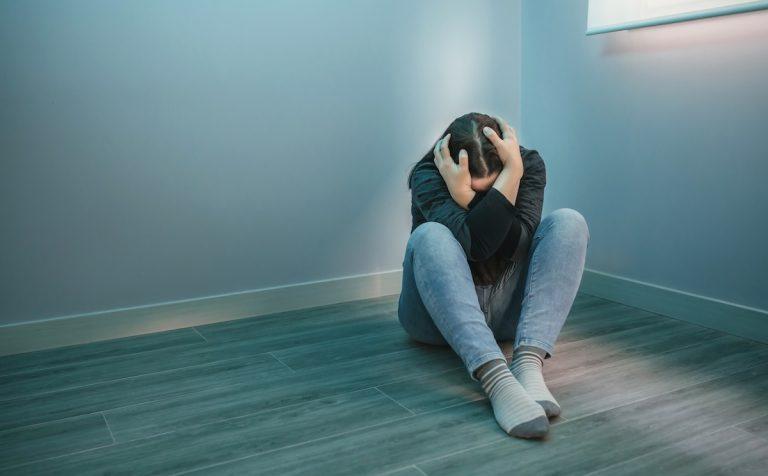 Unrecognizable woman with mental disorder and suicidal thoughts