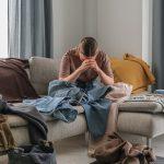 Spring cleaning,second hand,Fast fashion, the girl puts things in order in the closet. A bunch of colorful clothes. The concept of processing, second hand, eco, minimalism, consumption of goods