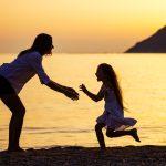 Mother and daughter having fun on beach